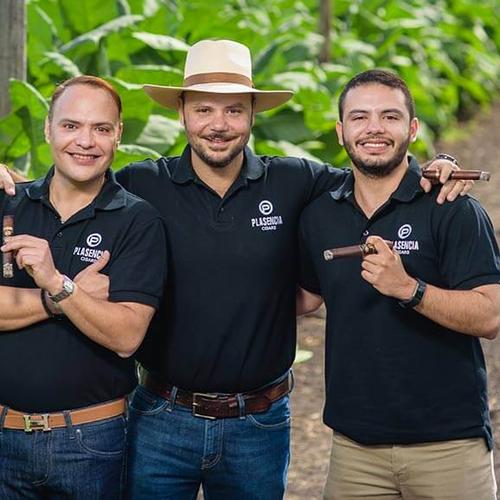 The Story of Cigars NH Cigars Three men holding cigars outdoors.